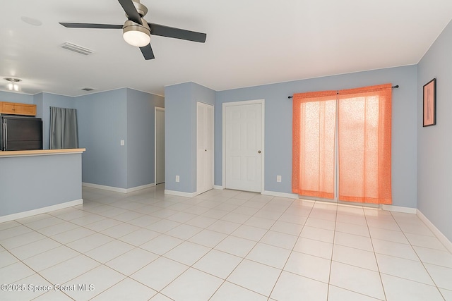 1040 Abada Ct NE Unit 109, Palm Bay, FL 32905 - unfurnished living room featuring baseboards, a ceiling fan, and light tile patterned flooring