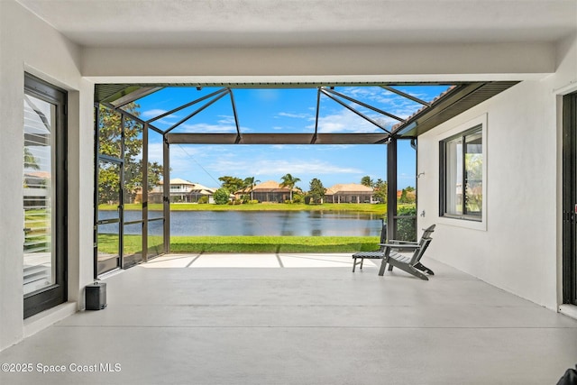 unfurnished sunroom featuring a water view