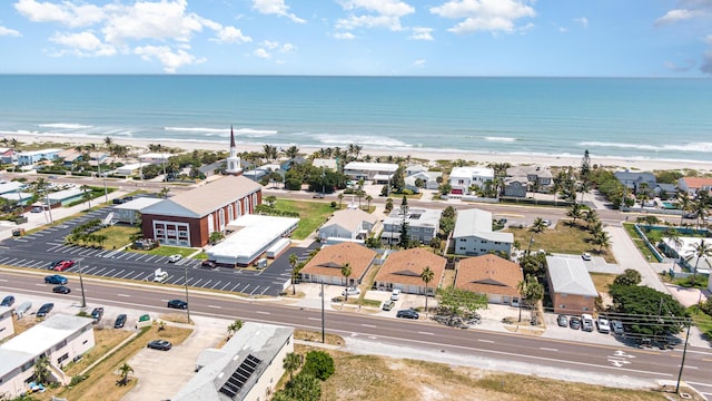 aerial view with a water view and a view of the beach