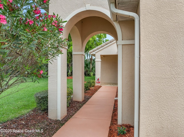 exterior space with a yard and stucco siding