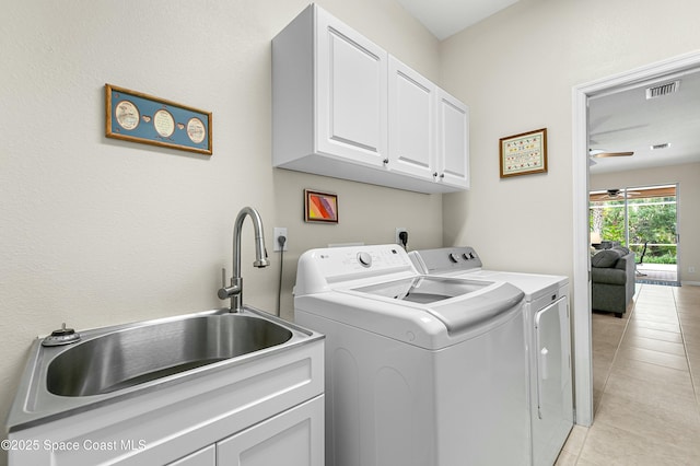 laundry area with cabinet space, a ceiling fan, light tile patterned flooring, a sink, and washer and dryer