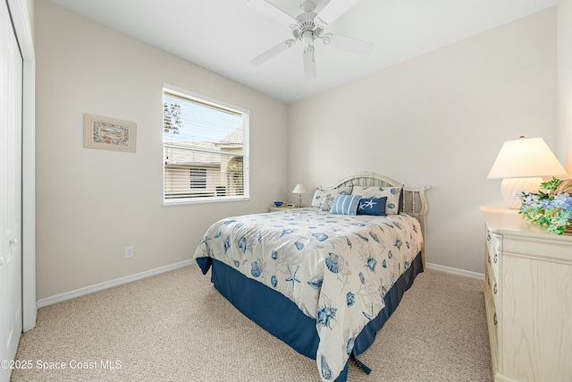 bedroom featuring a ceiling fan, light colored carpet, and baseboards