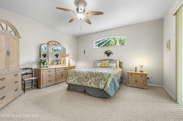 bedroom with baseboards, a ceiling fan, and light colored carpet