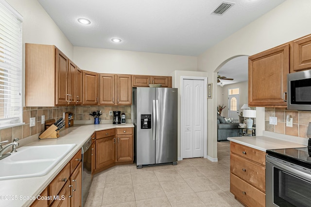 kitchen with visible vents, stainless steel appliances, a sink, and light countertops