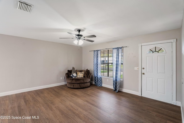 entryway with dark wood-style floors, ceiling fan, visible vents, and baseboards