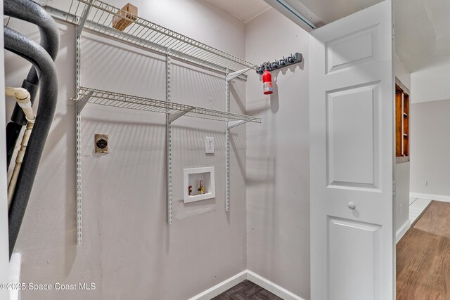 laundry room featuring laundry area, baseboards, wood finished floors, washer hookup, and electric dryer hookup