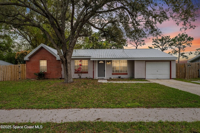 ranch-style house featuring a garage, fence, concrete driveway, and a yard