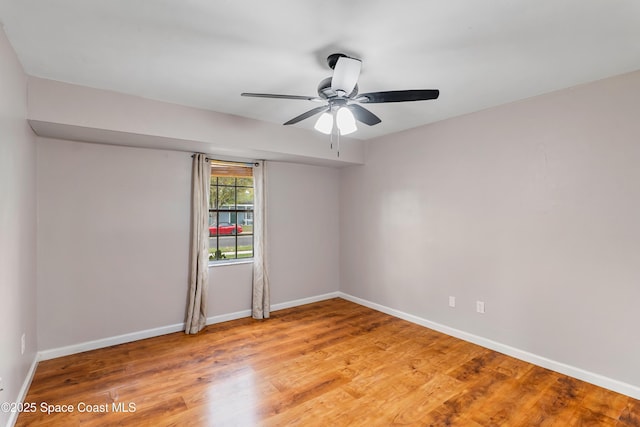 unfurnished room featuring baseboards, ceiling fan, and light wood finished floors