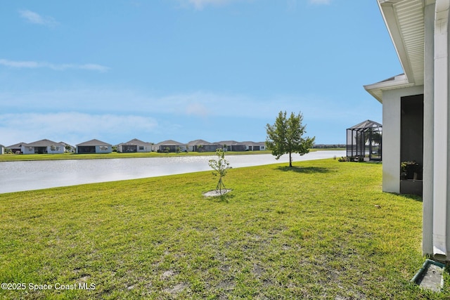 view of yard featuring a residential view and a water view