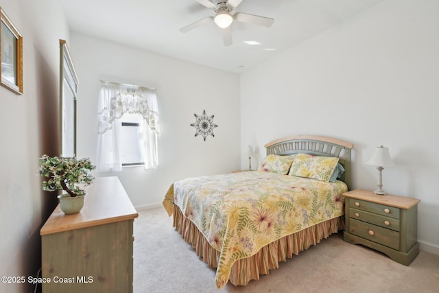 bedroom featuring baseboards, a ceiling fan, and light colored carpet