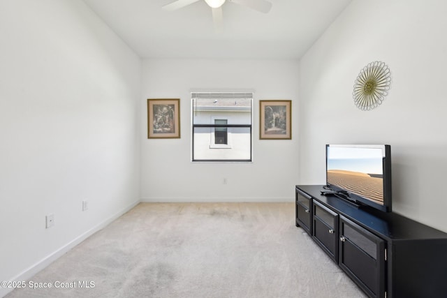 living area with light carpet, ceiling fan, and baseboards