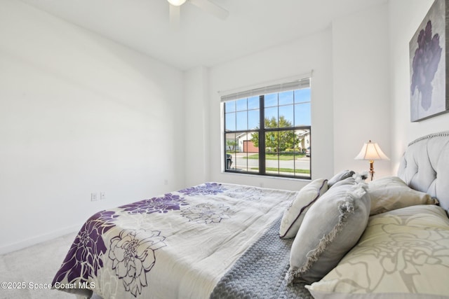 carpeted bedroom with a ceiling fan and baseboards