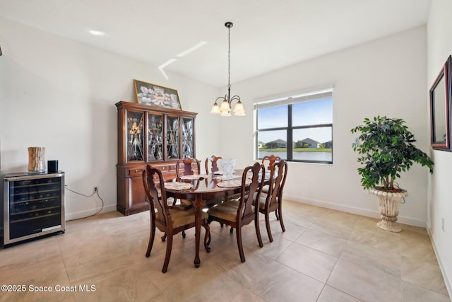 dining area featuring baseboards, wine cooler, light tile patterned floors, and a notable chandelier