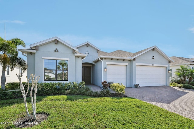 ranch-style home featuring an attached garage, roof with shingles, decorative driveway, stucco siding, and a front lawn