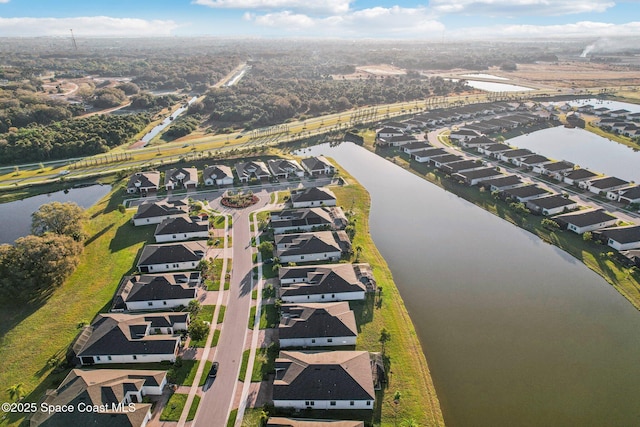 birds eye view of property featuring a water view and a residential view