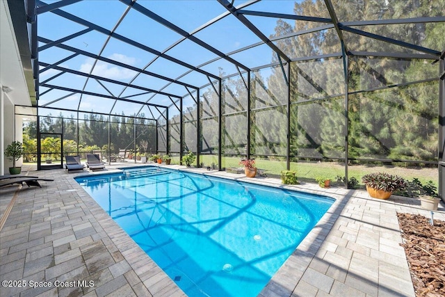 pool with a patio area and glass enclosure