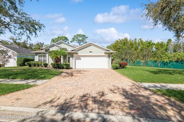 view of front facade with a front yard and a garage