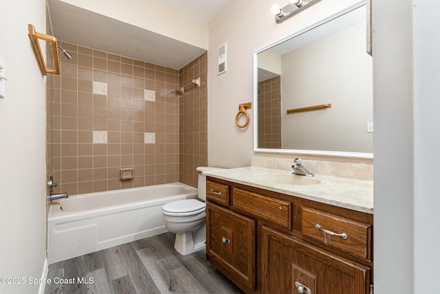 full bathroom with wood finished floors, bathtub / shower combination, toilet, vanity, and visible vents