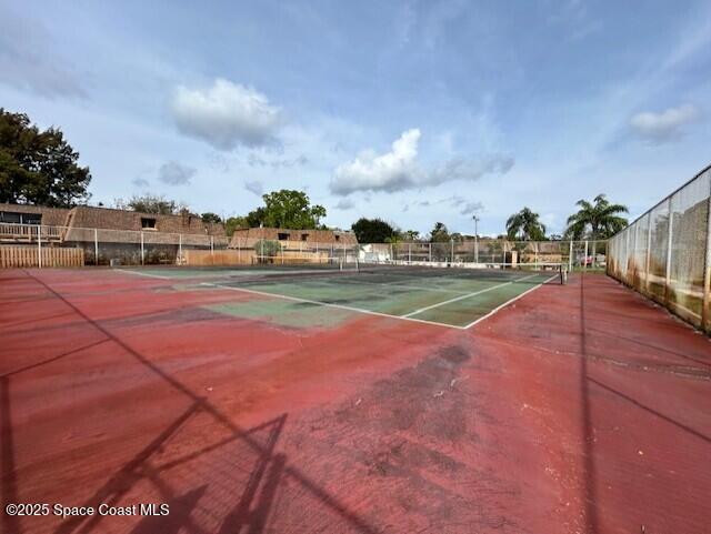 view of sport court with fence
