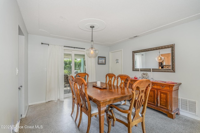 dining room with a textured ceiling