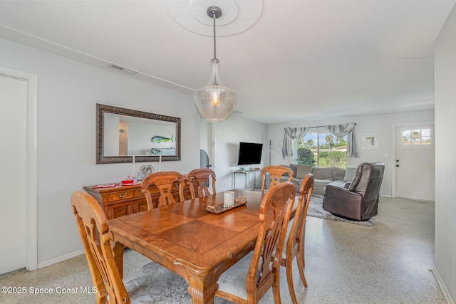 dining room featuring a textured ceiling
