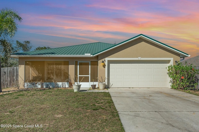 ranch-style home with a garage and a lawn