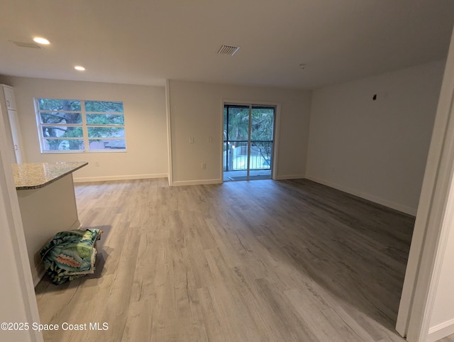 unfurnished room with light wood-type flooring