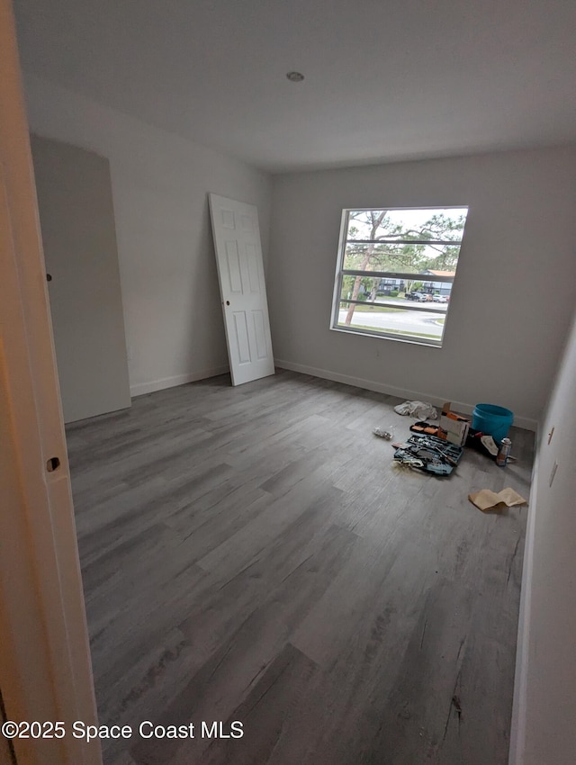 unfurnished bedroom with hardwood / wood-style floors