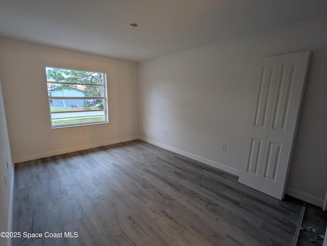 empty room with wood-type flooring