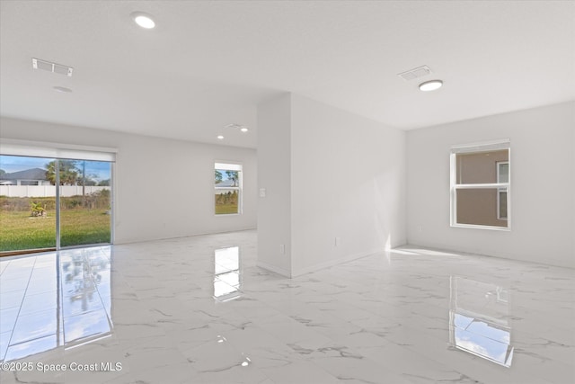 unfurnished room featuring recessed lighting, marble finish floor, and visible vents