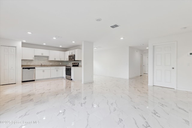 unfurnished living room with marble finish floor, a sink, visible vents, and recessed lighting