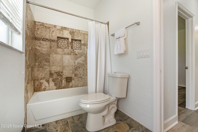 full bath with toilet, baseboards, and shower / tub combo with curtain