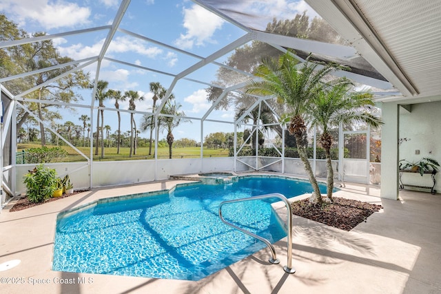 view of swimming pool featuring glass enclosure, a patio area, and a pool with connected hot tub