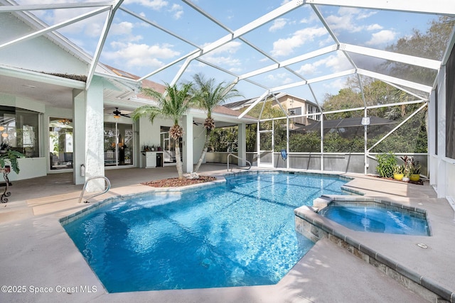 view of swimming pool with a patio, a lanai, a pool with connected hot tub, and a ceiling fan