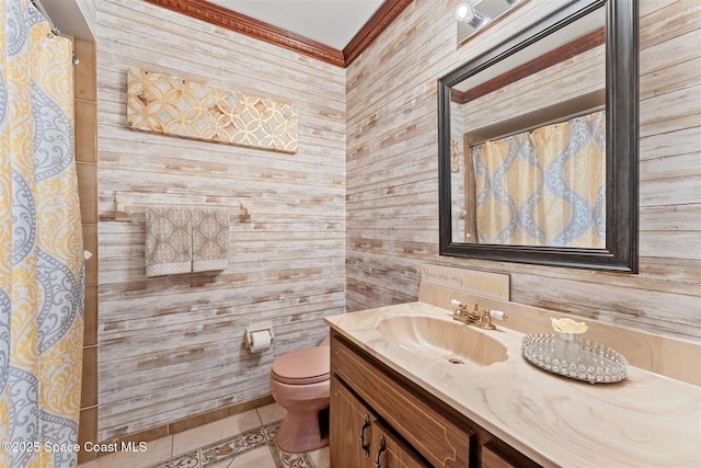 bathroom featuring tile patterned flooring, crown molding, vanity, and toilet