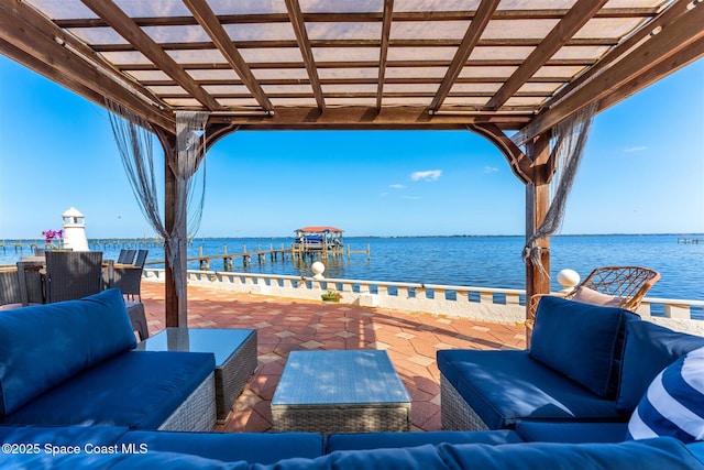 view of patio featuring a water view, an outdoor living space, and a pergola