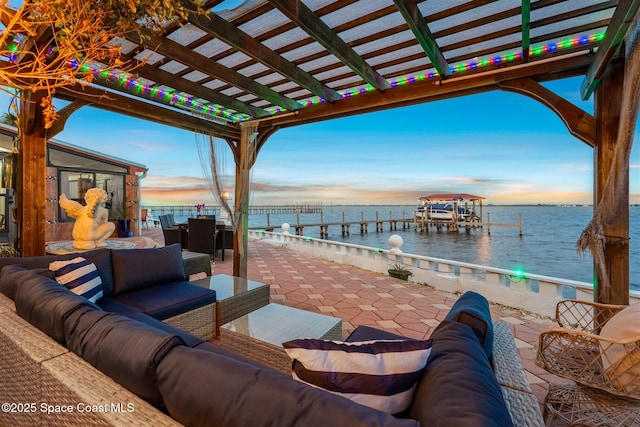 view of patio featuring an outdoor hangout area, a dock, a water view, and a pergola