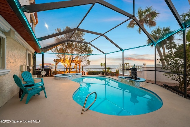 view of pool with a water view, glass enclosure, a pool with connected hot tub, and a patio