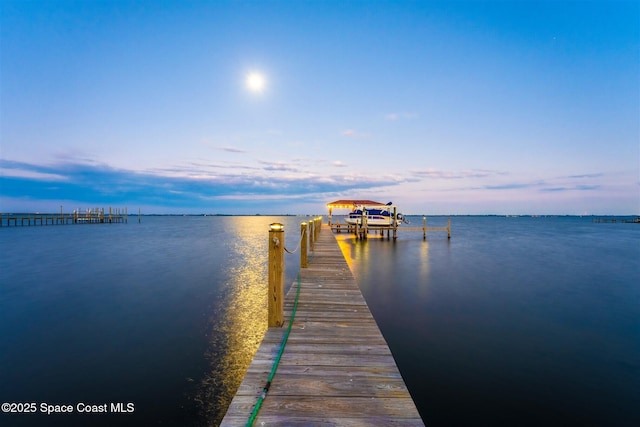 view of dock featuring a water view and boat lift