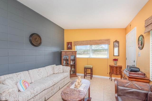 living area featuring light tile patterned flooring and baseboards