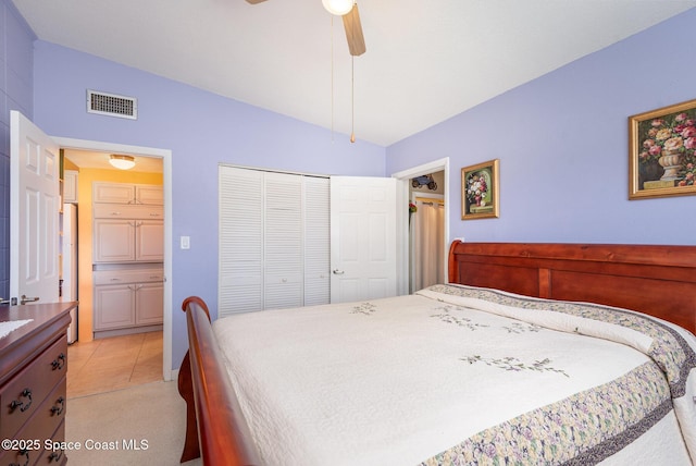 bedroom featuring a ceiling fan, visible vents, vaulted ceiling, and a closet