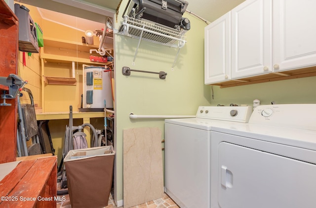 laundry area featuring brick floor, cabinet space, washer and clothes dryer, and electric water heater