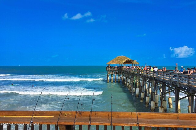 dock area featuring a pier and a water view