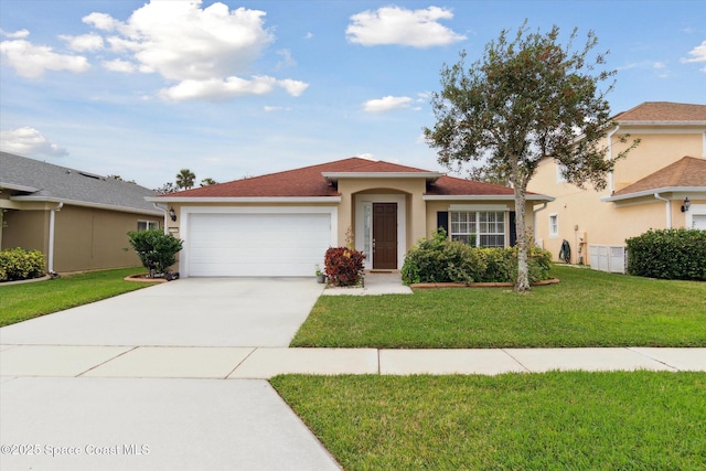 view of front of property with a front yard and a garage