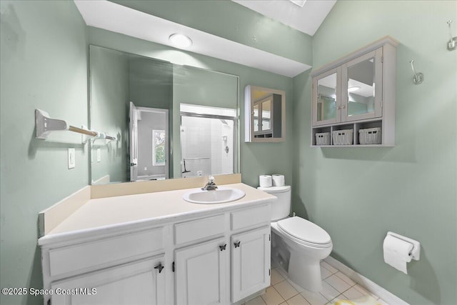 bathroom with tile patterned flooring, toilet, vanity, baseboards, and an enclosed shower