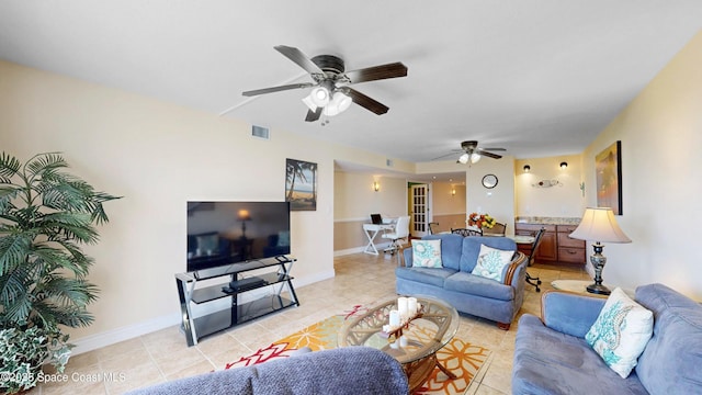 living area featuring light tile patterned floors, baseboards, and visible vents