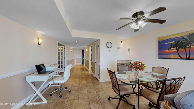 home office featuring light tile patterned floors, ceiling fan, baseboards, and french doors