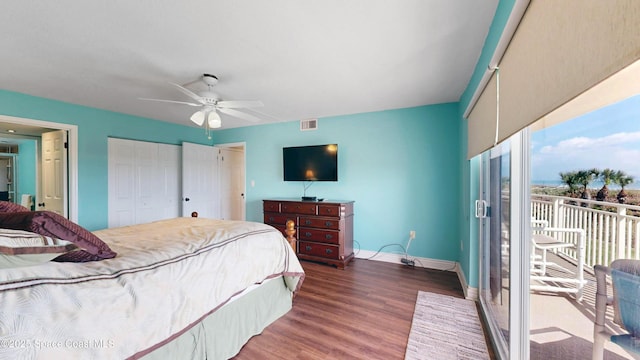 bedroom with wood finished floors, a ceiling fan, visible vents, baseboards, and access to outside