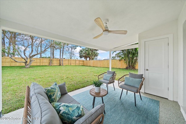 view of patio with outdoor lounge area, a fenced backyard, and a ceiling fan