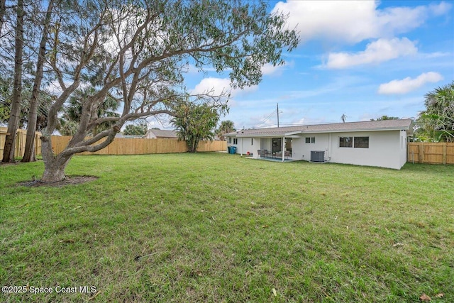 view of yard with cooling unit and a fenced backyard